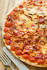 pizza on brown wooden background