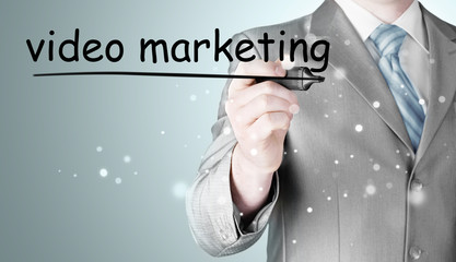business man writing Video Marketing