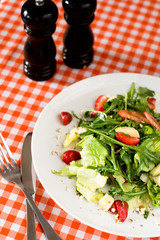 A refreshing summer salad with arugula, cheese and strawberries