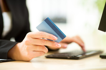 business woman holding credit card on laptop for online payment concept