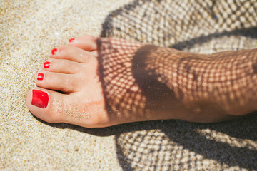 Womans feet on the beach