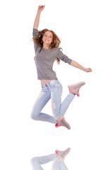 Cute smiling girl in gray blouse and jeans isolated on white