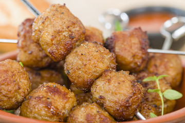 BBQ Meatballs - Meatballs on metal skewers served with chilli dip.
