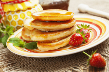 Homemade pancake with honey and strawberry