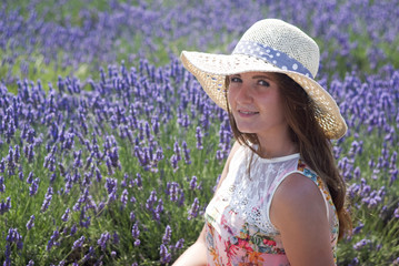 Young woman in lavender field with hat