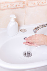 Woman washing hands close up