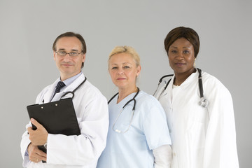 Threesome of self confident medical specialists smiling and looking at the camera