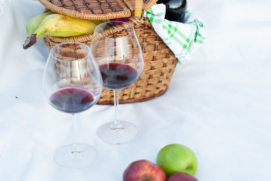 Outdoor picnic setting with red wine