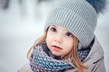 close up portrait of cute baby girl on winter walk