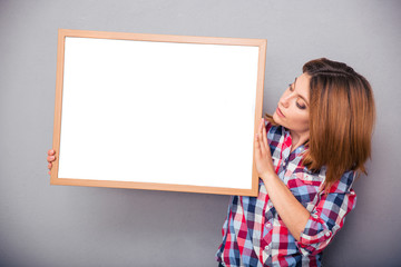 Woman presenting something on a blank board