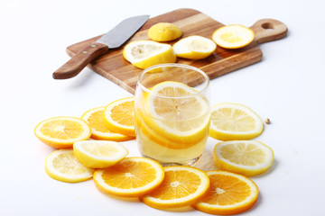 drink and stack of citrus fruits slices.
