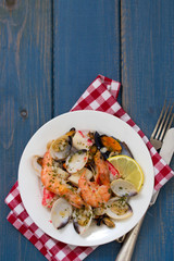 seafood salad on plate on blue wooden background