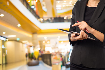 Businesswoman using digital tablet in the shopping mall.