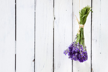 Bundled Lavender Flowers Drying At Rustic White Wall