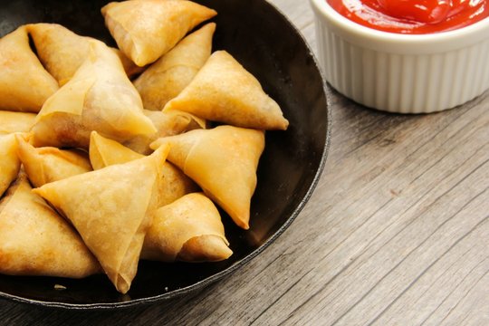 Samosas - Popular Indian deep fried snack with potato filling and covered with crispy crust