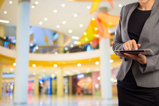 Businesswoman Using Digital Tablet In The Shopping Mall.