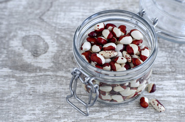 Red and white spotted beans in a glass jar