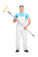 Young male house painterholding a paint roller