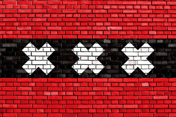 Fototapeta premium flag of Amsterdam painted on brick wall