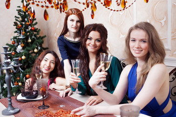 Two friends on a party, girl sitting at the holiday table