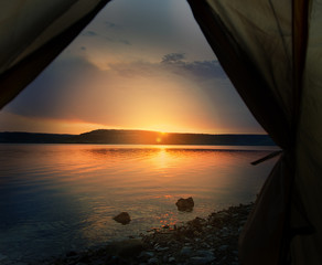 View from the green tent on lake coastline closeup