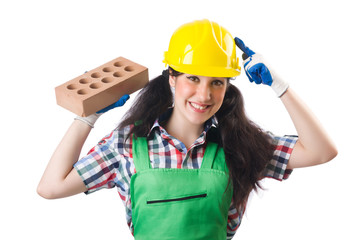 Female workman in green overalls holding brick isolated on white