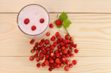 Smoothie from wild strawberries in a glass and wild  strawberries