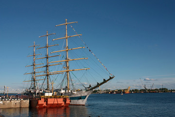 three-masted schooner moored to the dock