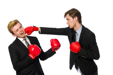 Pair of businessmen boxing on white