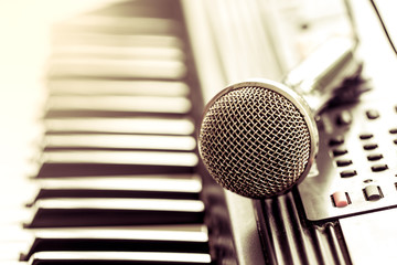classical microphone on keyboard in vintage color tone