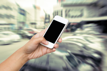 woman hand hold smart phone, tablet,cellphone on blur motion of