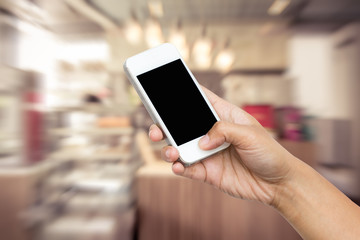 woman hand hold smart phone, tablet,cellphone on coffee shop blu