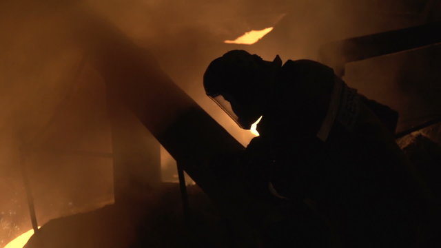 Silhouette of man on a background of burning metal