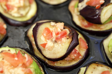 Baked eggplant with tomatoes on a tray