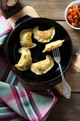 Five dumplings in a frying pan