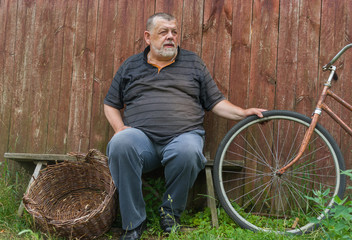 Ukrainian senior farmer sitting on a bench