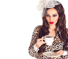 Beautiful retro brunette woman portrait in leopard blouse with red plump lips in vintage veil hat with white cup in her hands isolated on white