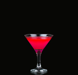Cosmopolitan cocktail in nice red color in front of a black background