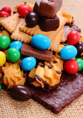 A lot of sweets on jute burlap, unhealthy food