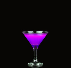 refreshing purple martini served  on a black background garnished with fresh mint