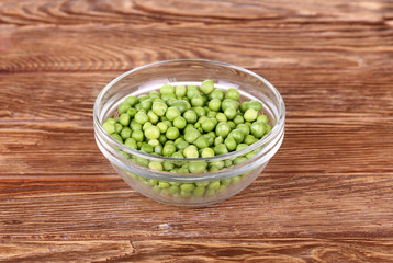 peas on a wooden bowl in a glass