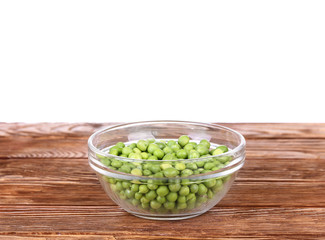 peas on a wooden bowl in a glass