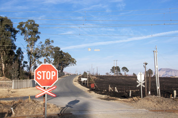 Burnt Farm Field with Railway Crossing in Foreground