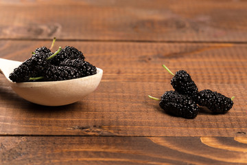 Mulberry on wood background