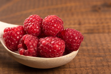 Ripe sweet raspberries on table