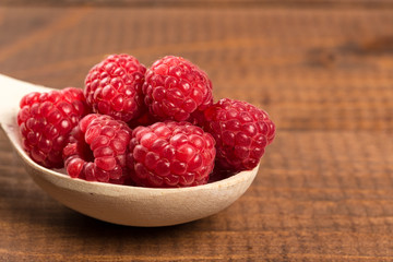 Ripe sweet raspberries on table