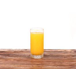 Fresh orange juice on the wood background