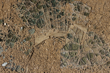 The broken pane of glass in the sand