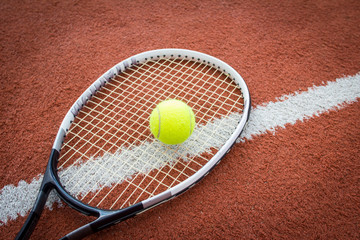 Tennis racket and ball on court