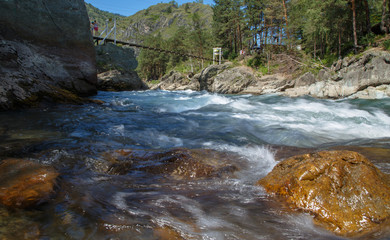 During the stormy mountain river among stones